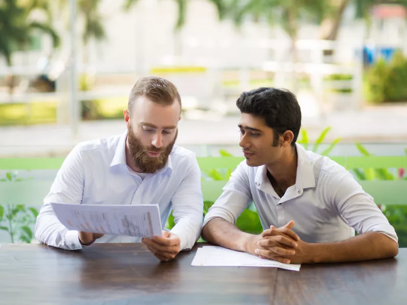 Two students discussing guidance on how to choose a college major for academic success.