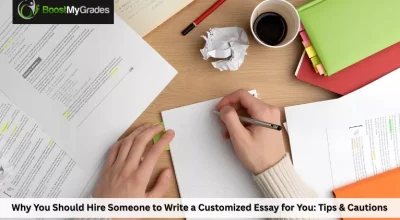 Hands writing on a notepad surrounded by study materials, books, and coffee
